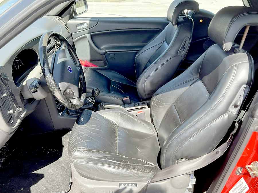 Inside, the black leather with Viggen-specific details, The interior remains largely intact, though the driver’s seat shows wear, and a seam has separated in the back seat.