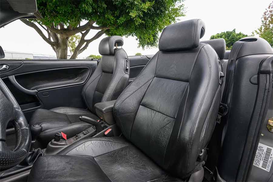 The distinctive leather seats of the 2001 Saab 9-3 Viggen Convertible, known for their unique design and comfort.