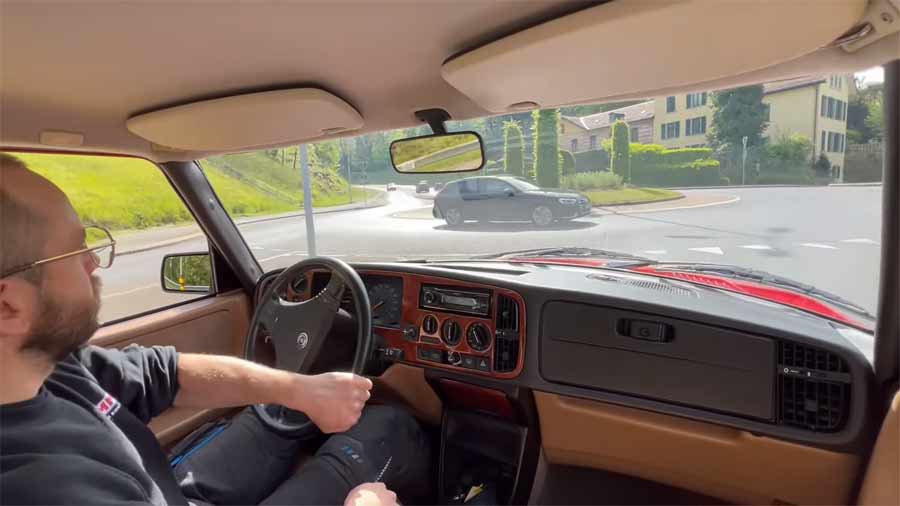 Inside the cockpit of the classic 1993 SAAB 900 Turbo Aero during a test drive, highlighting the vintage charm of its well-preserved interior and dashboard.